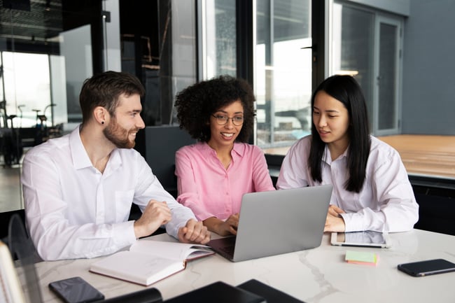 colleagues-working-together-laptop-documents