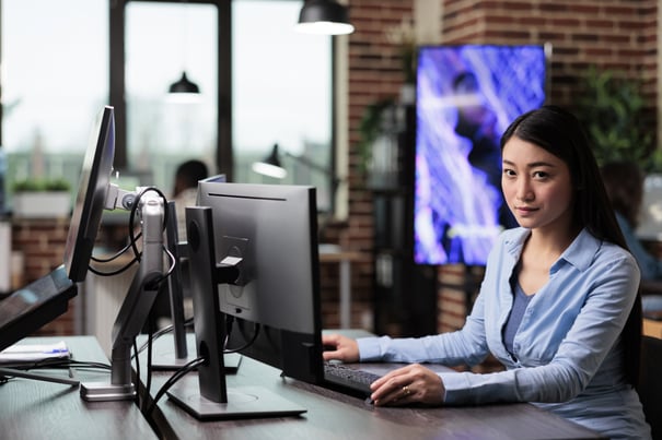 company-office-worker-production-department-working-computer-while-designing-modern-graphics-beautiful-asian-creative-artist-sitting-desk-while-developing-digital-art-looking-camera