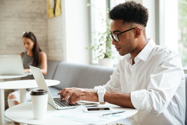 concentrated-young-african-man-sitting-coworking-1