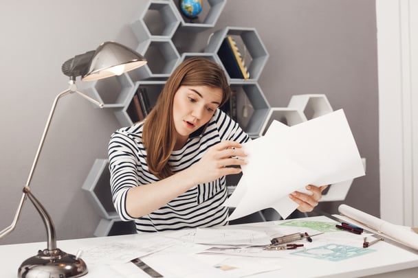 portrait-beautiful-young-dark-haired-concentrated-european-female-freelance-designer-talking-phone-with-team-leader-trying-organize-papers-tomorrow-s-meeting