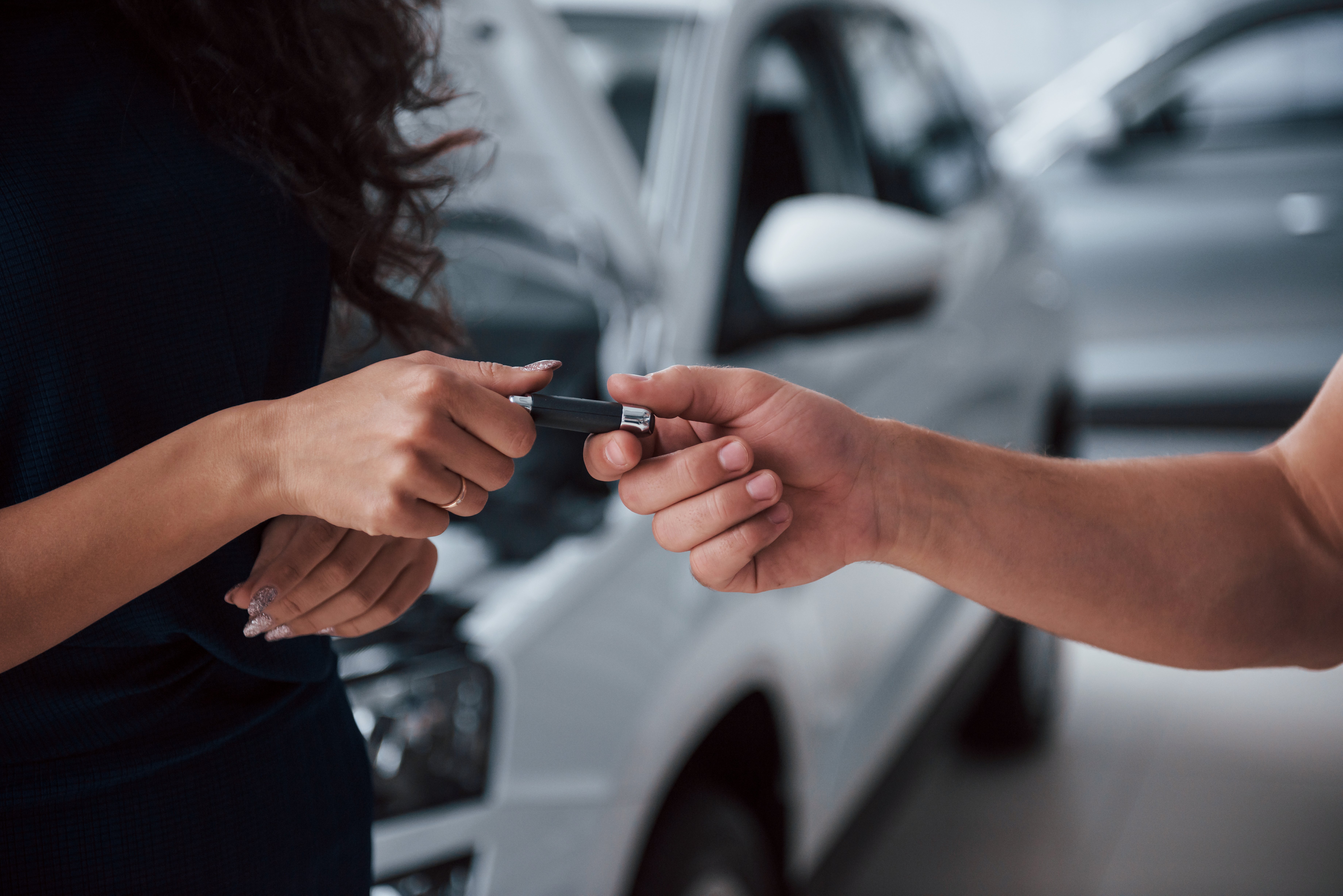side-view-woman-auto-salon-with-employee-taking-her-repaired-car-back