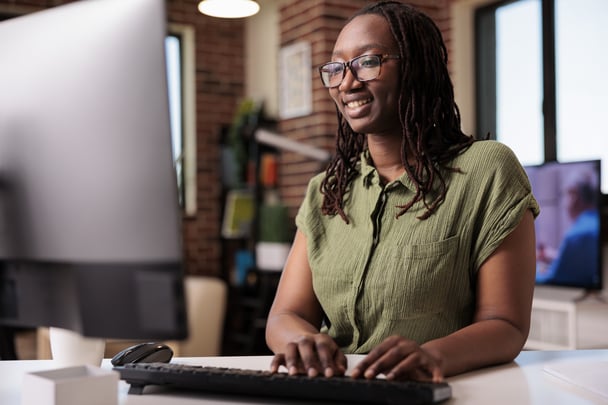 smiling-african-american-programmer-relaxing-looking-funny-content-computer-screen-while-typing-keyboard-freelancer-laughing-with-friends-while-chatting-using-pc-home-living-room