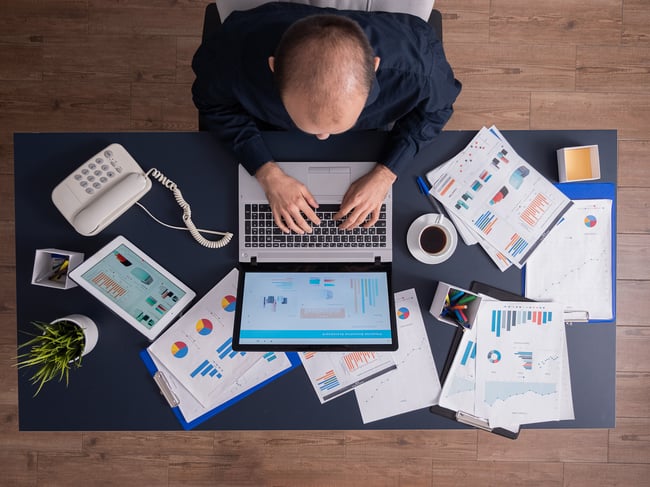 top-view-business-man-corporate-office-sitting-desk-typing-laptop-working-financial-statistics-business-strategy