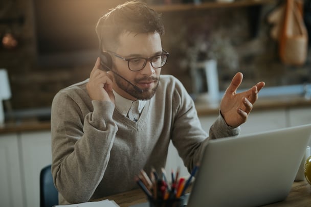 young-entrepreneur-having-conference-call-computer-while-working-home